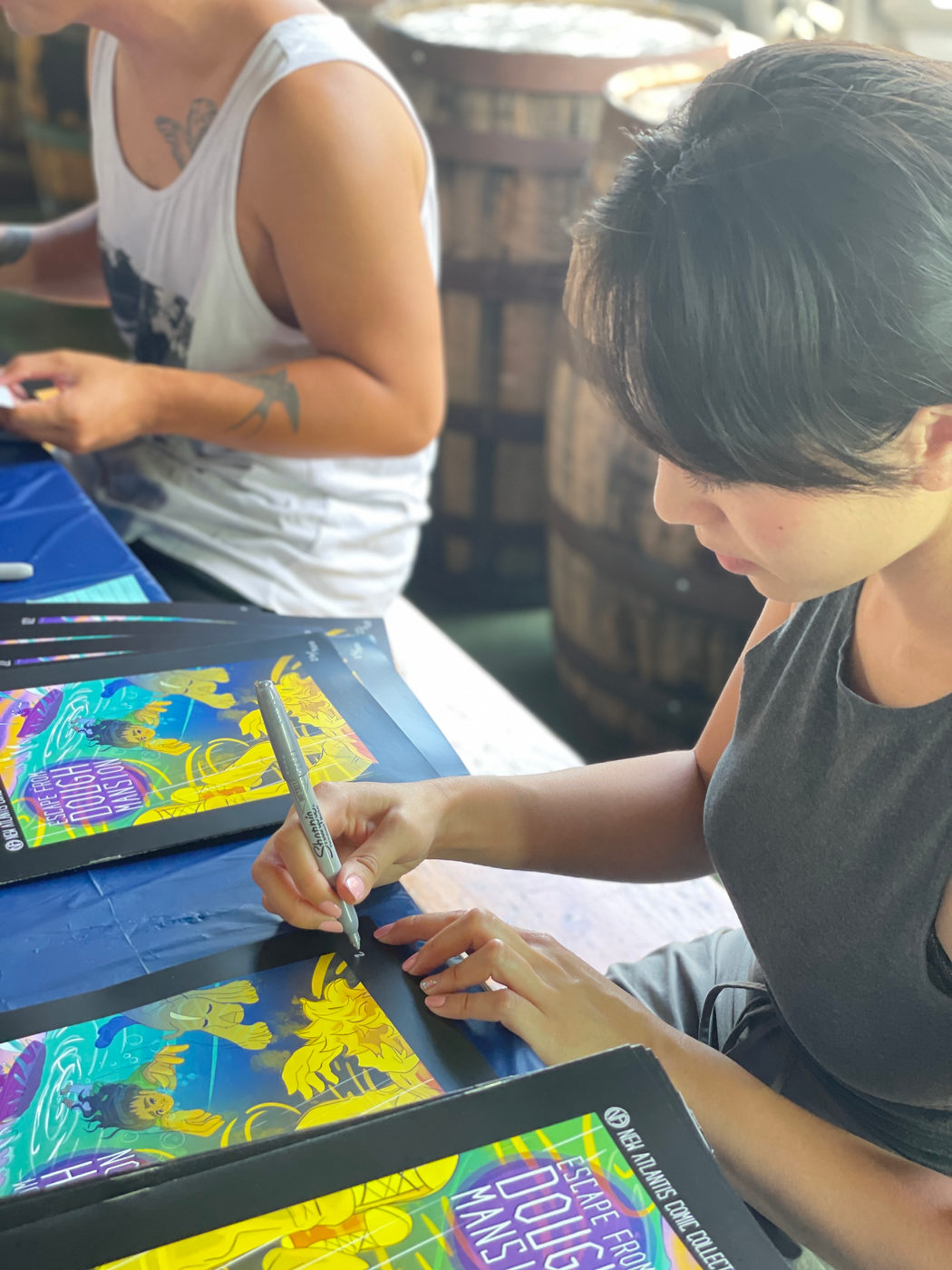 Artist signing Escape From Dough Mansion at Trademark Brewery